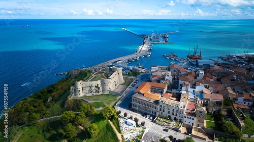 Aerial shot of the 15th-century castle overlooking the calm sea and the busy Ortona harbor.