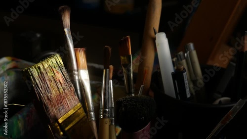 Collection of Used Artist Paintbrushes in Container with Paint Palette 