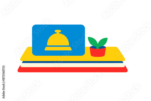 Hotel reception bell and potted plant on a layered surface