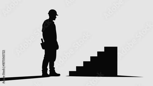 Construction worker standing beside staircase