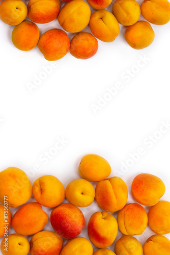 Ripe apricots with orange and red skin on white background. Flat lay, top view, copy space