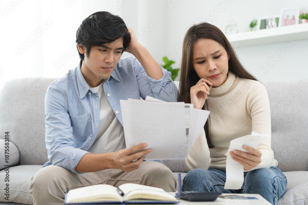 Fototapeta premium Family financial concept, Stressed wife and husband have a problem to pay loan can not pay credit card debt.