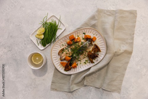 fish served with vegetables, mushrooms, carrots and fresh green onions