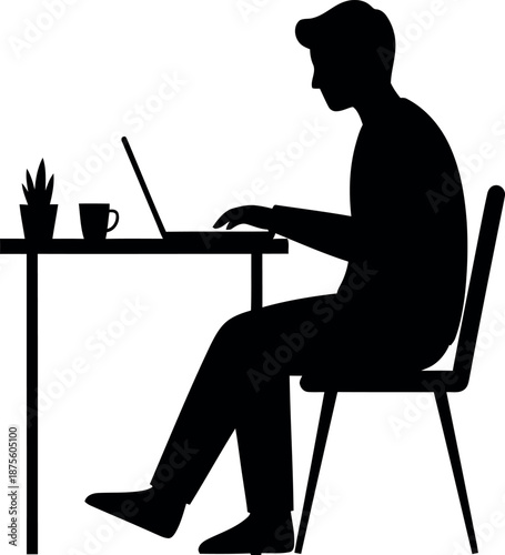 Silhouette of a person working on a laptop at a desk
