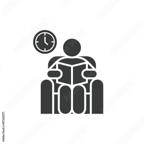 a person sitting and reading a book next to a clock