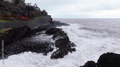 Dramatic photograph capturing tumultuous sea and rugged shoreline