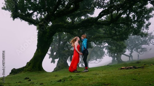 Couple performing graceful dance outdoors surrounded by mist