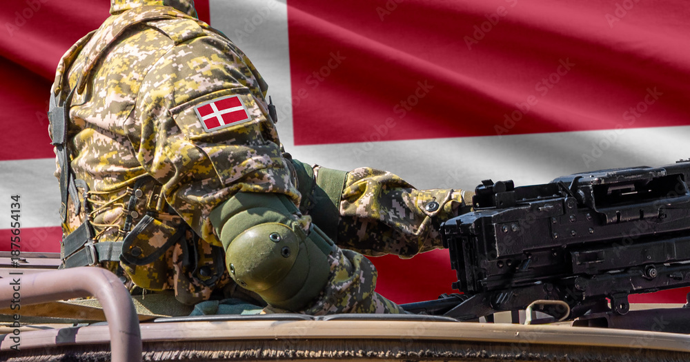 Fototapeta premium Denmark flag with soldier at machine gun turret in front of it. Closeup side view.