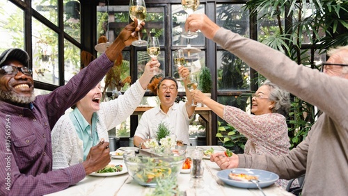 Εκτύπωση καμβά Group of diverse seniors enjoying a meal, raising glasses in celebration