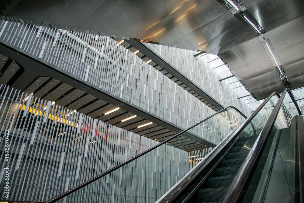 Fototapeta premium Contemporary Mall Interior with Escalator and Geometric Architecture