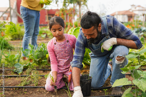 Tablou pe pânză Indian father and daughter gardening together at house organic garden - Educatio