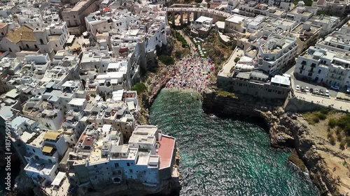 Aerial View of Polignano a Mare with Historic Buildings and Crowded Beach, Puglia, Southern Italy