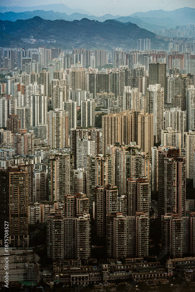 Fototapeta premium Dense Cityscape with Distant Mountains - Urban Aerial View