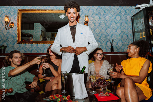 Canvas Print Young friends celebrating together with drinks at elegant party