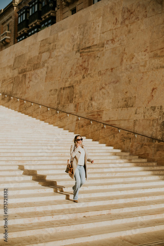 Woman walks down stairs in ...
