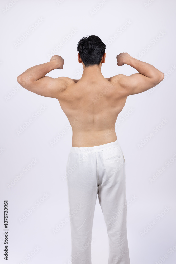 Fototapeta premium Back view of man showing double biceps