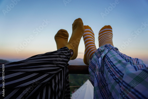 Colorful Socks on Relaxed Feet Against Scenic Sunset Sky