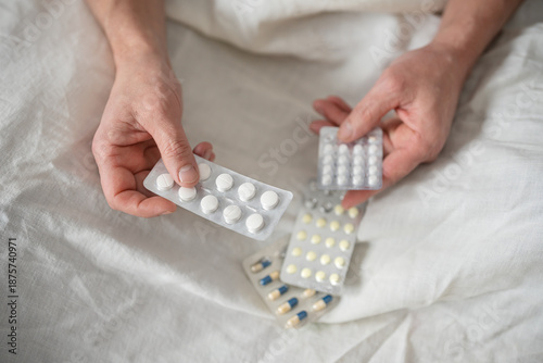 Blister packs of pills in senior man hands