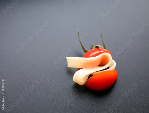 red tomato and pasta on a black background