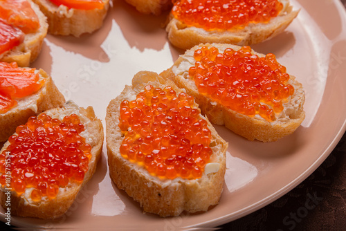 Close-up of canap s with red caviar and trout on a plate