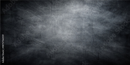 A dark and vintage black and white grunge metal background features a rough textured surface with a dirty gray concrete pattern and an old paper backdrop design