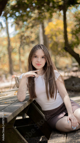 young woman sitting on a bench in the park