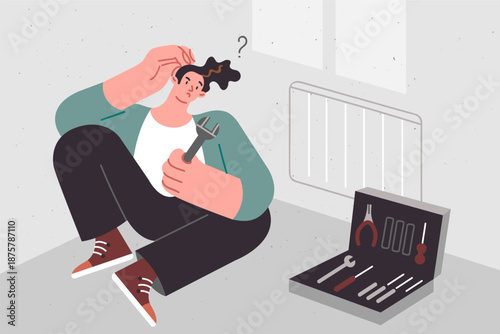 Man plumber sits near radiator and scratches head, not knowing how to solve problem