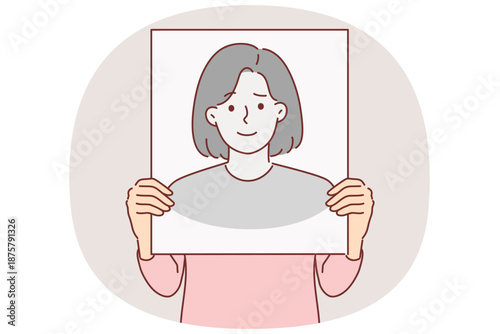 Anonymous woman hides face behind banner with fake portrait to remain incognito and leave no traces