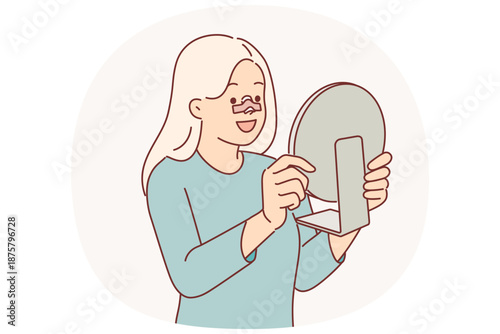 Happy woman after rhinoplasty surgery on nose looks in mirror and rejoices at improvement own image