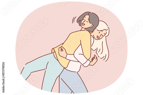 Women friends fool around by lifting each other on backs and laughing to stretch spines