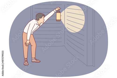 Man reads giant book with interest, holding lantern to illuminate encyclopedia at night