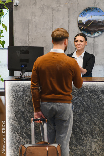 Konstfotografi Guest checking in at hotel reception desk