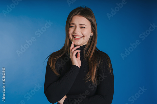 Studio picture of cheerful woman showcasing professional attire and warmth