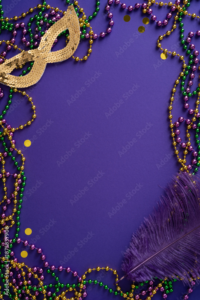 Fototapeta premium Vibrant vertical Mardi Gras scene with a gold sequined mask, purple and green beads, and a purple feather against a rich purple background, conveying carnival spirit, festive energy