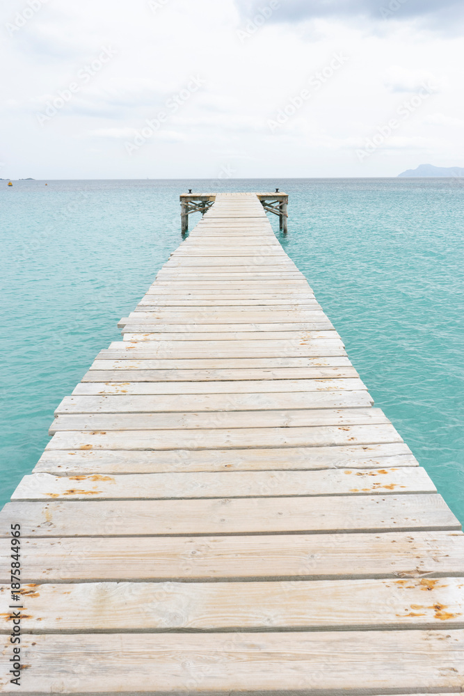 Fototapeta premium Wooden pier extending into turquoise water.. Palma de Mallorca, Spain
