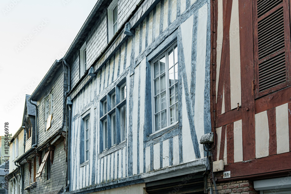 Naklejka premium Facade of an old wooden building with blue and brown beams in Normandy, France