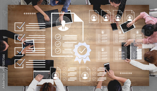 Quadro em tela A diverse team collaborates in a modern workspace, reviewing important documents on laptops and tablets, ensuring effective communication and workflow efficiency