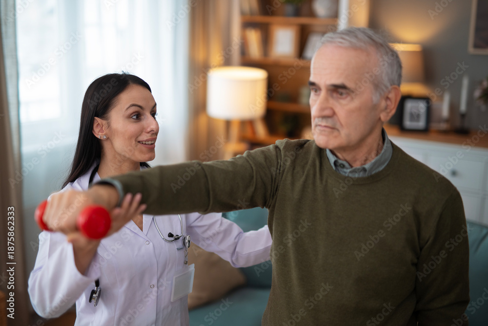 Fototapeta premium Nurse assisting senior man with physical therapy exercise