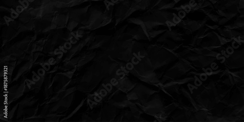 black paper background. Black dark crumpled roudh paper texture background.
