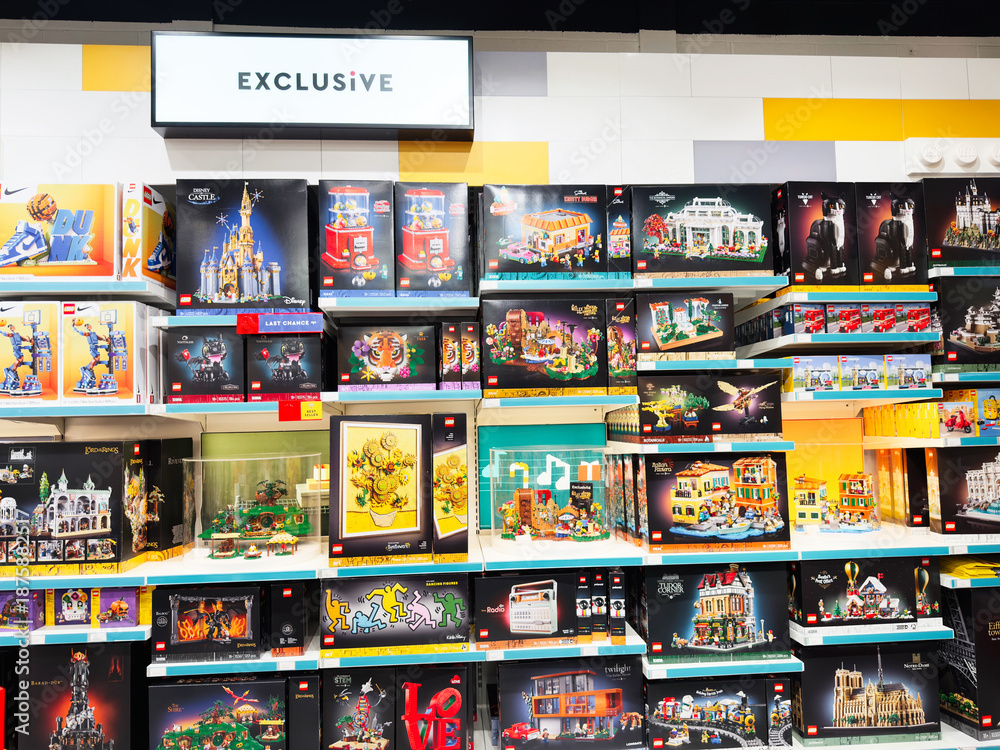 Naklejka premium Exclusive colorful lego sets on display in a Manchester shop, bright shelves full of toys