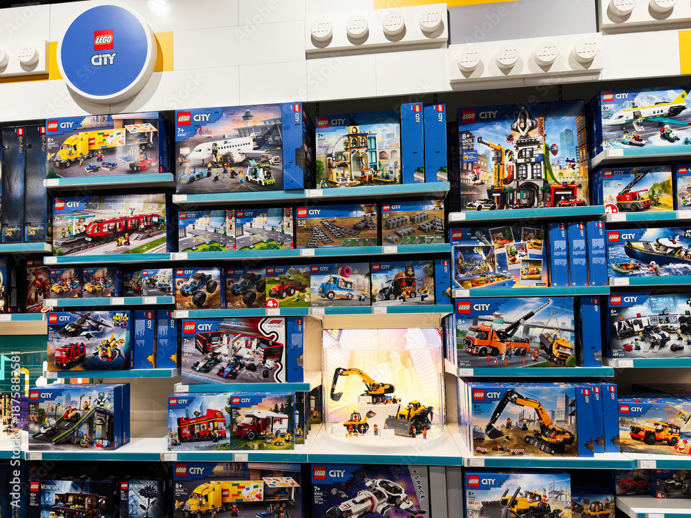 Fototapeta premium Lego City display in Manchester UK store shelves featuring boxes and colorful brick sets