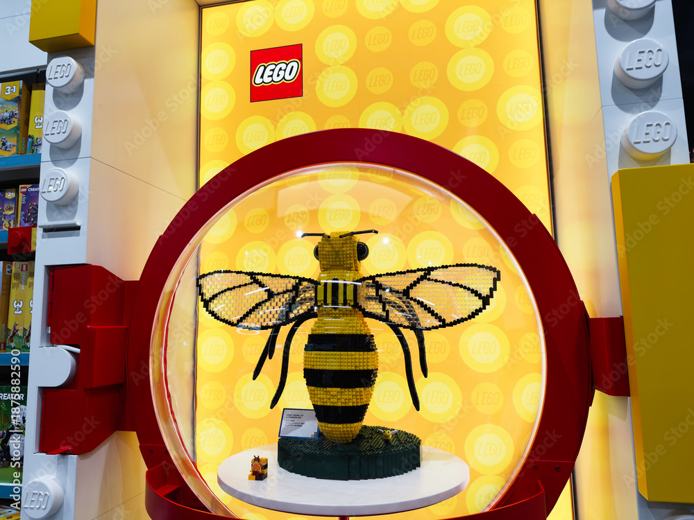 Fototapeta premium Lego bee sculpture on bright yellow display at Lego store in Manchester UK