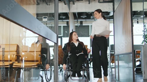Team members discuss plans for a project in a modern coworking space focusing on inclusion and accessibility for all professionals
