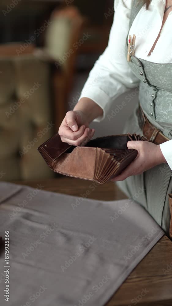 Unrecognizable waitress counting change from a wallet and placing coins ...