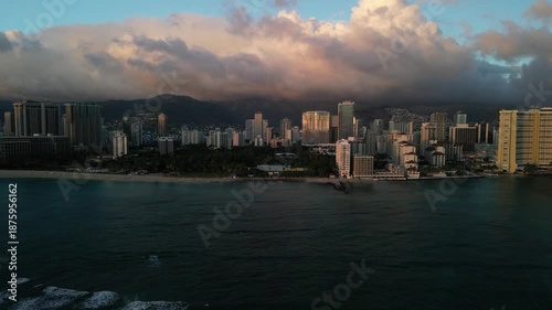 Wallpaper Mural Drone aerial right lateral fly along Waikiki beach and Honolulu skyline with dramatic storm clouds, calm ocean and city hotels at golden hour in Hawaii USA
 Torontodigital.ca