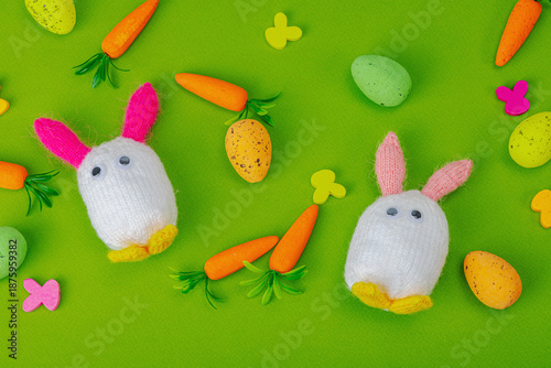 Handmade Easter concept. Knitted bunnies with traditional decoration. Festive symbols, greeting card