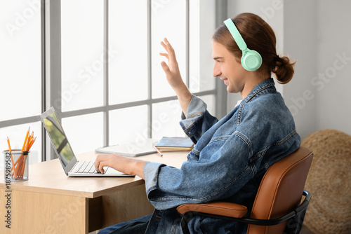 Young man in headphones wit...