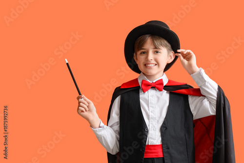 Photos Little magician on orange background