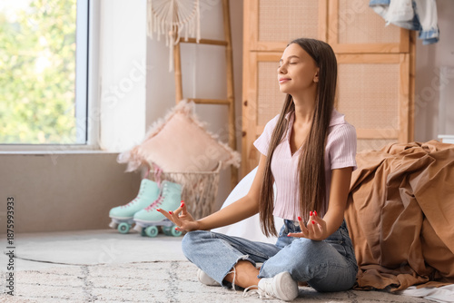 Teenage girl meditating in ...