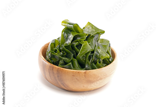 Slika na platnu Seaweed wakame in wood bowl on white background.
